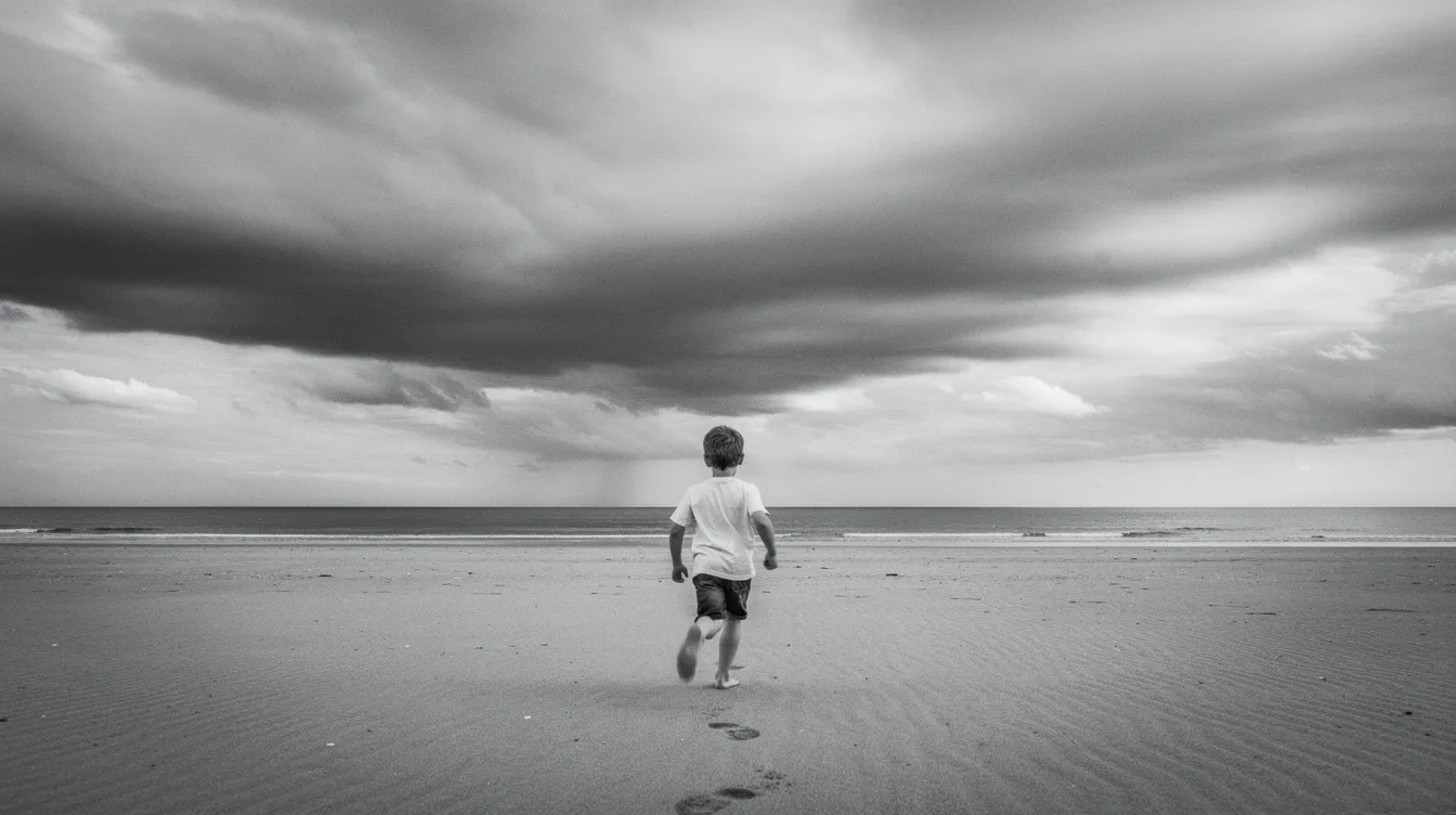 Ein Junge rennt allein über einen weiten, leeren Sandstrand in Richtung Meer, während der dramatische Himmel in Schwarz-Weiß gehalten ist. Diese Szene erinnert an die filmische Ästhetik von François Truffaut und den klassischen Film "Les Quatre Cents Coups", der die Themen von Rebellion und Kindheit behandelt.